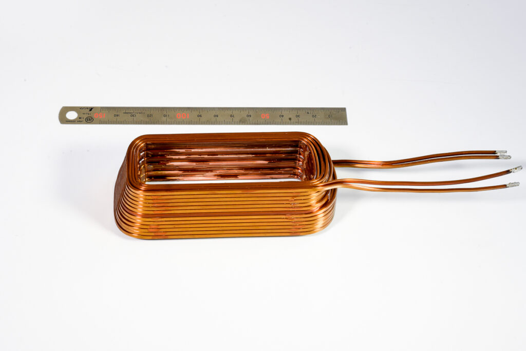 Flat alpha layered stepped coil